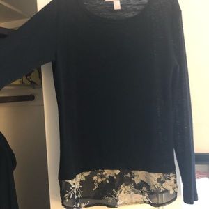 Black long sleeve shirt with flowers sheer bottom.